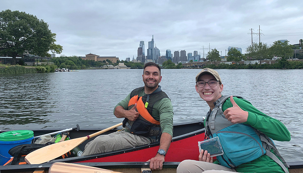 Jeff Cocci '23 (left) and Beth Myers '17 pose in front of the Philadelphia skyline during the annual Perki-Bay Expedition, which is a fiv...