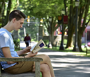 reading student on bench