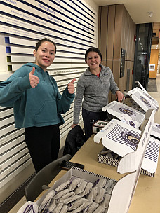 Rachel Conhoff and Paige Bristow sell cookies in the IDC to raise funds for UNICEF to support ear...