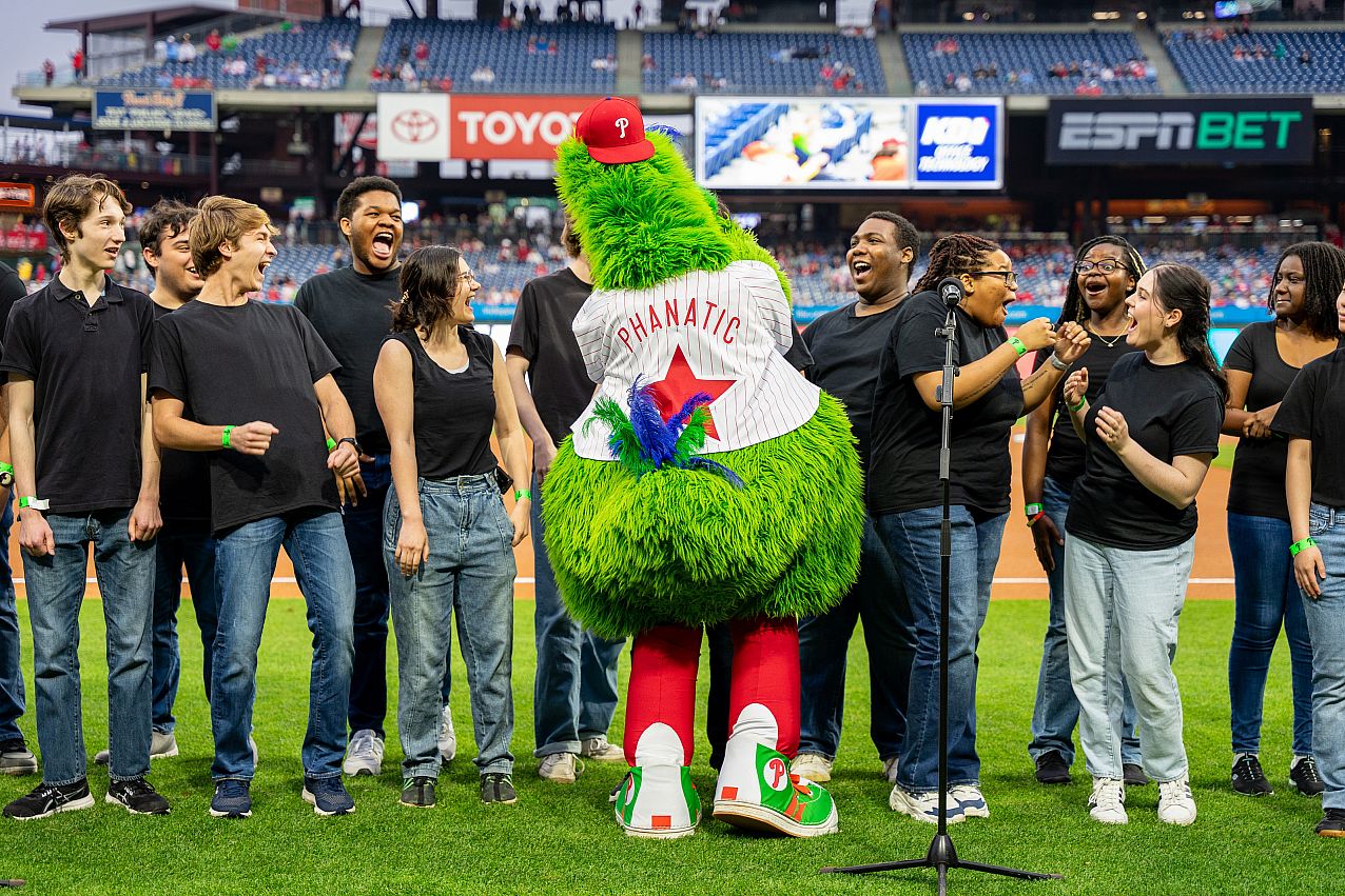 The Philly Phanatic interacts with Voices of Ursinus before singing National Anthem  at the Phillies 2024