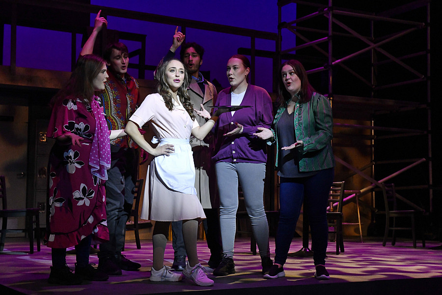 Group of theater majors performing on stage during a play.