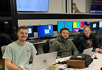 Mill Heinze '24, Jay Kosa '25, and Alyssa Himmelreich '26 at Michigan State University in the user area monitoring detectors and data dur...