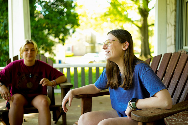 2 students talking on porch candid
