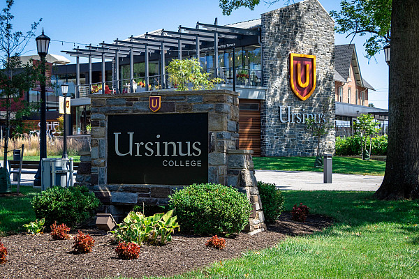 Ursinus College sign and Schelllhase Commons at entrance to campus