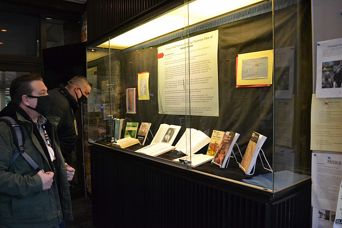 Chief Brad KillsCrow and Assistant Chief Jeremy Johnson view the exhibit in Myrin Library.
