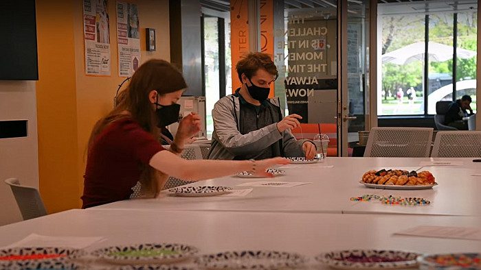 Christine Heren '22 is joined by fellow students at a bracelet-making workshop.