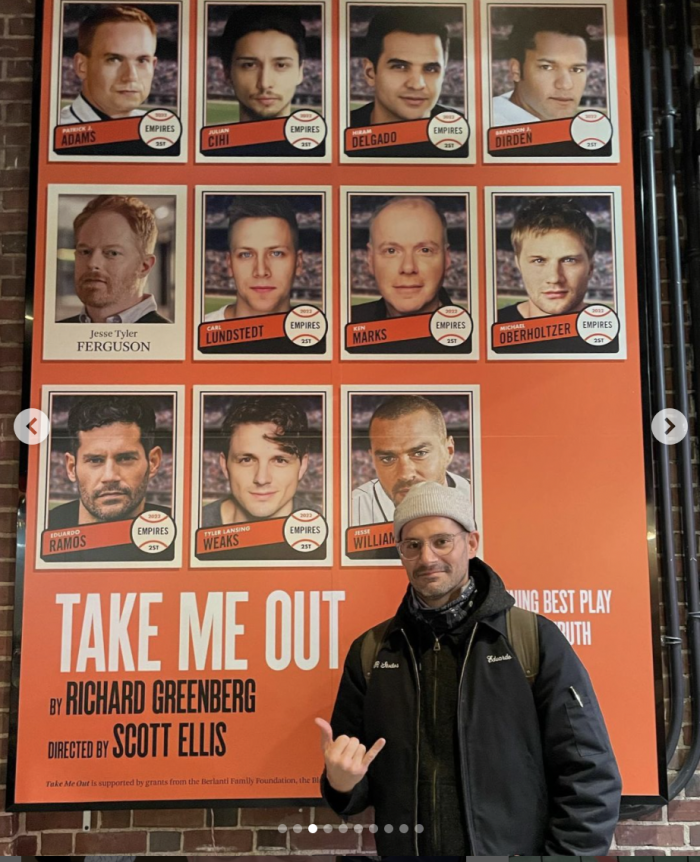 Eduardo Ramos standing in front of Take Me Out poster