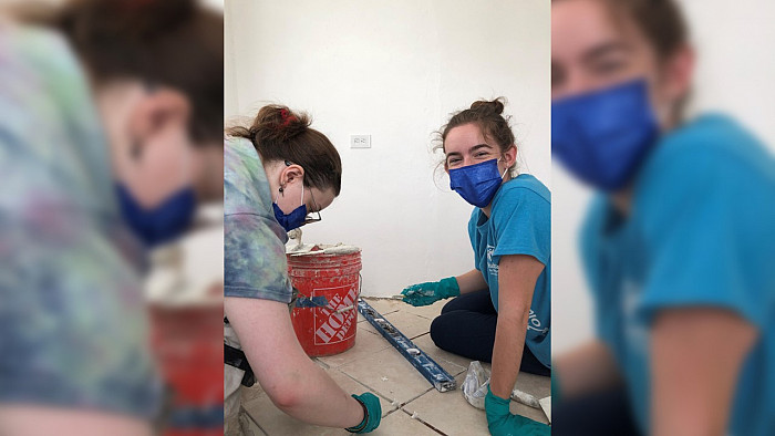 Abby Peabody '22 and Kevyn Dewees install a floor in a house in Puerto Rico.