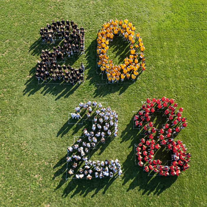 The Class of 2028 in formation on the Facilities Intramural Field for the class photo. August 23, 2024