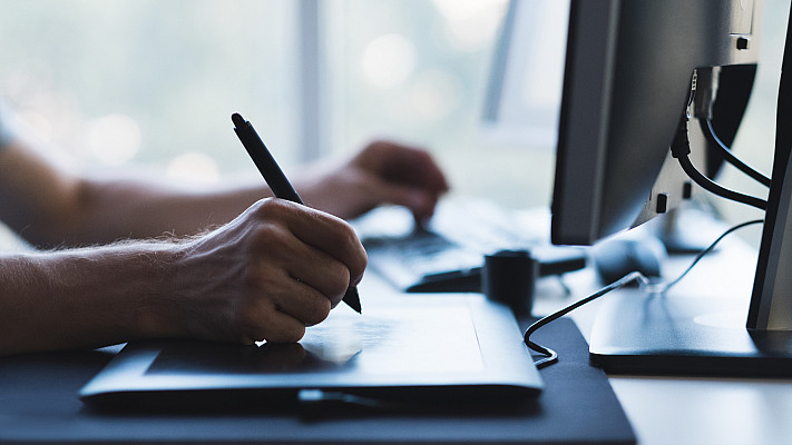 man hands drawing on graphic tablet with stylus. designer or digital artist at work