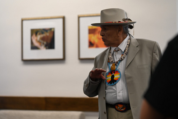 Men speaking a the Delaware Tribe of Indians dressed in native attire.