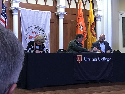 Ursinus College board members performing a signing at the Delaware Tribe of Indians event.