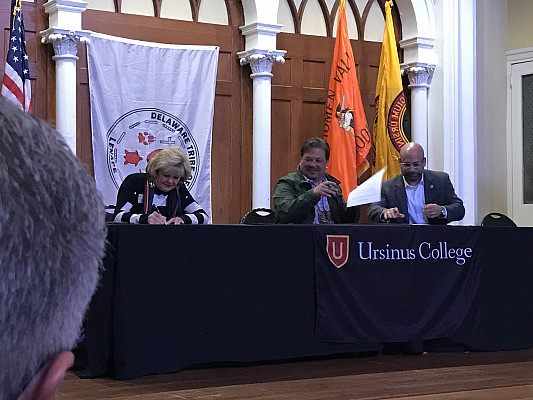 Ursinus College board members performing a signing at the Delaware Tribe of Indians event.