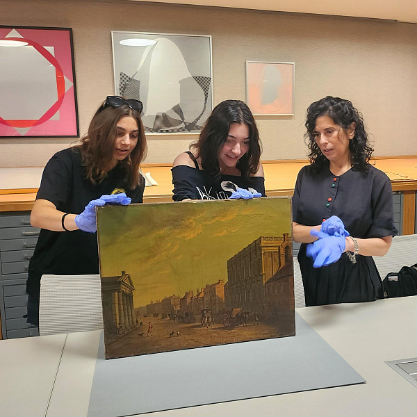 Two students eagerly examined the back of a painting from the Berman's permanent collection this week. They researched the piece last sem...