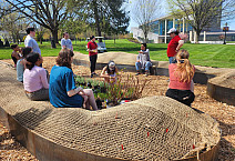 Syd Carpenter with BIO 334 students at the hügel site to prepare and organize the garden's plants.