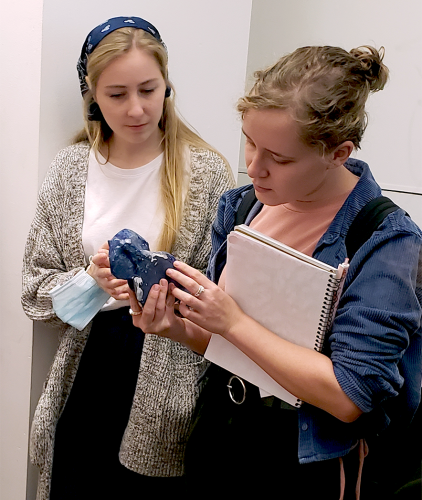Two museum studies students admiring Dika's recent piece. 