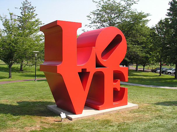 Photo of a red LOVE sculpture outside.