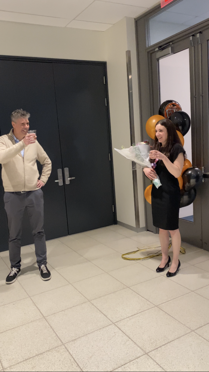 Traditional graduation toast with advisor