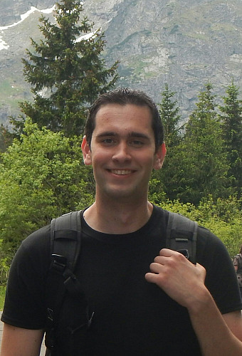 Christopher Sadowski standing in front of a mountain range