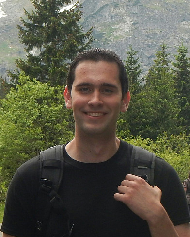Christopher Sadowski standing in front of a mountain range