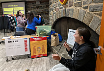 Volunteers sort clothes and count participants at a BearShare pop-up event.