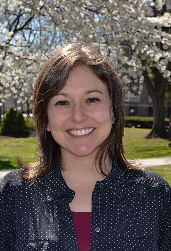 Leah Joseph standing in front of a blossoming tree