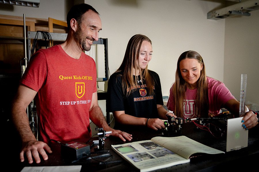 Physics professor Tom Carroll works with students in the Ultra-cold Quantum Dynamics Lab.