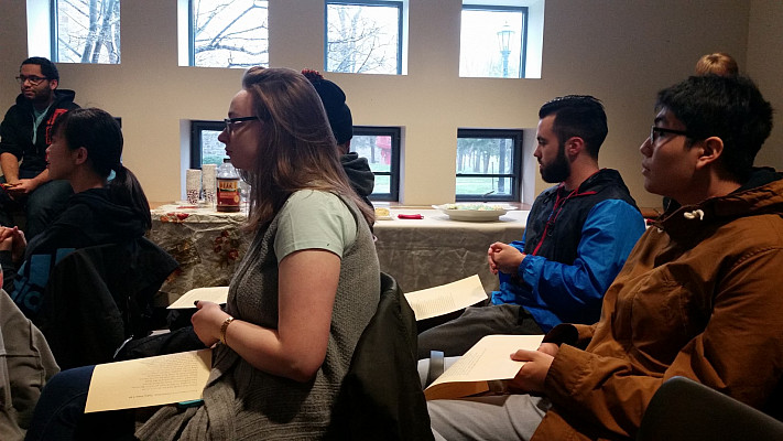 Members of the audience read the opening of the Canterbury Tales.