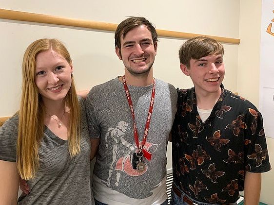 Three students standing for a photo.