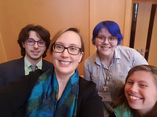 Prof. Throop and students pose for a fun picture after successfully presenting their work!