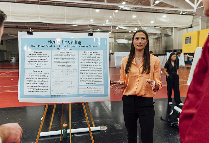 Student presenting research to others.