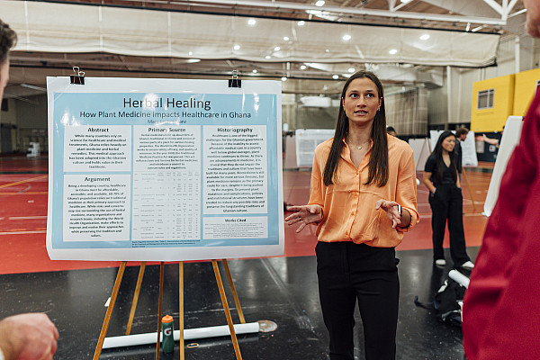 Student presenting research to others.