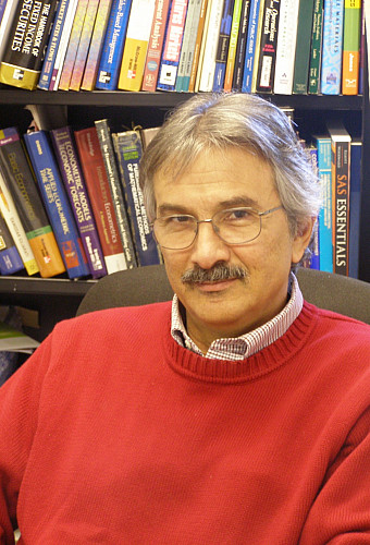 Photo of Andrew Economopoulos in a library