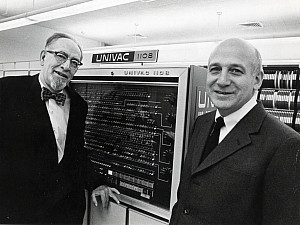 Photograph of two gentleman, one being John Mauchly, standing in front of a UNIVAC machine.