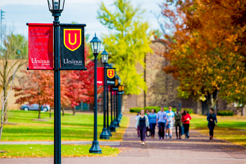 Students strolling the grounds during the fall.