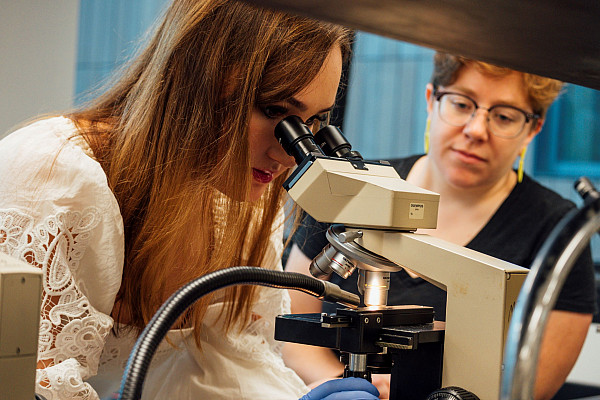 Students using a microscope in a lab.