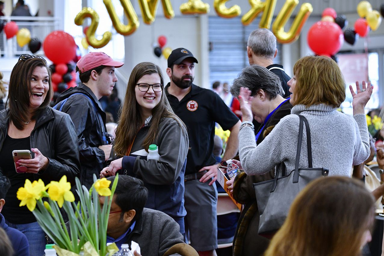 Group of parents and newly admitted students conversating at the Admitted Students Day event.