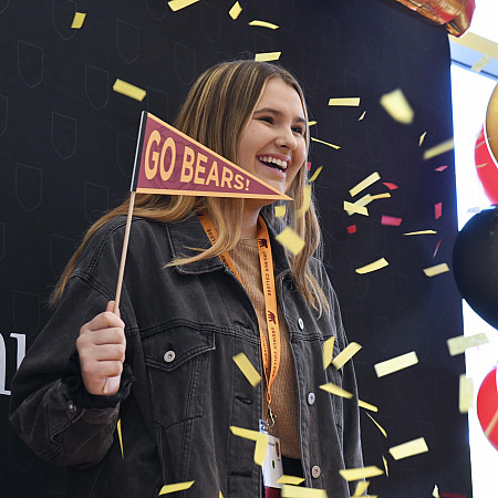 Admitted Students Day 001 student with go bears sign and confetti