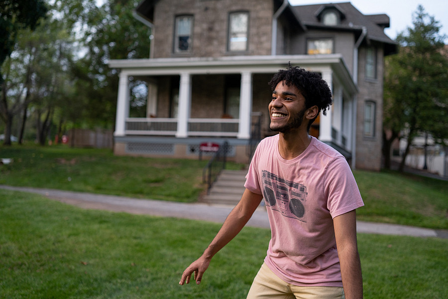 Student playing frisbee on Omwake  Hall lawn. Ursinus has over 22+ active Main Street residential houses for upperclassmen.