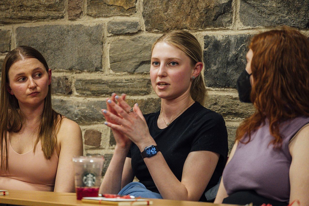 History Alumni Panel Photo of three college students sitting at a table talking.