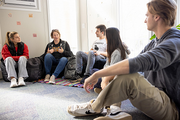 Health Promotion director, Katie Bean and students talking in the Hive
