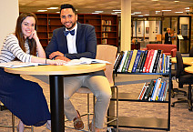 UCSG President Abi Wood and Vice President Hermes Paez check out the new textbooks for the Textbook Resource Pilot Program.