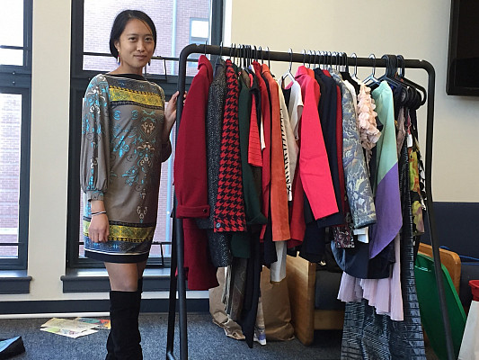 Senior Rebecca Fong shows off some of the hundreds of clothes donated for a fashion show. Proceeds go toward helping educate girls in Sie...