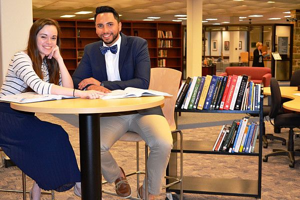 UCSG President Abi Wood and Vice President Hermes Paez check out the new textbooks for the Textbook Resource Pilot Program.