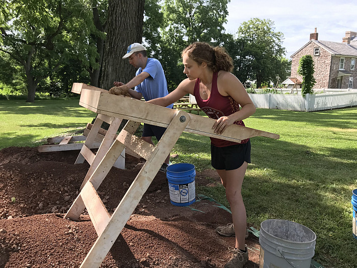 Neve Durrwachter '21 sifts through soil in search of artifacts at the Speaker's House in Trappe.