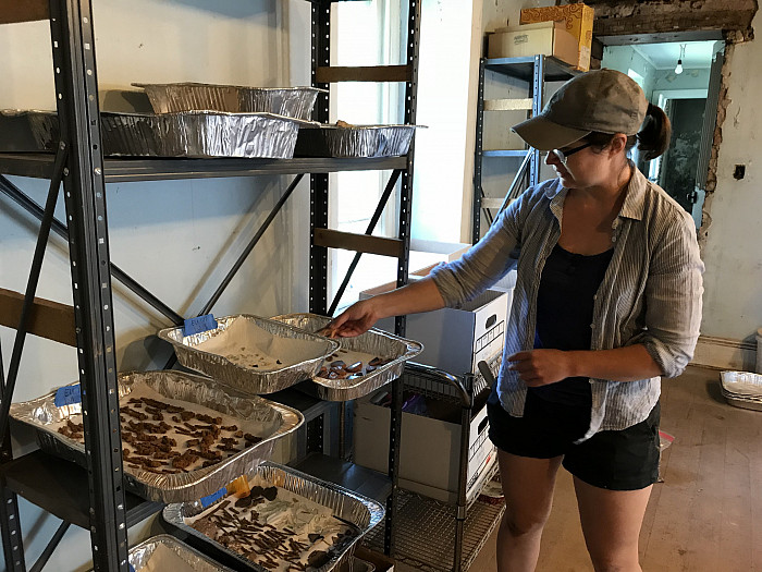 Instructor Lydia Garver shows off some of the artifacts discovered on the site.