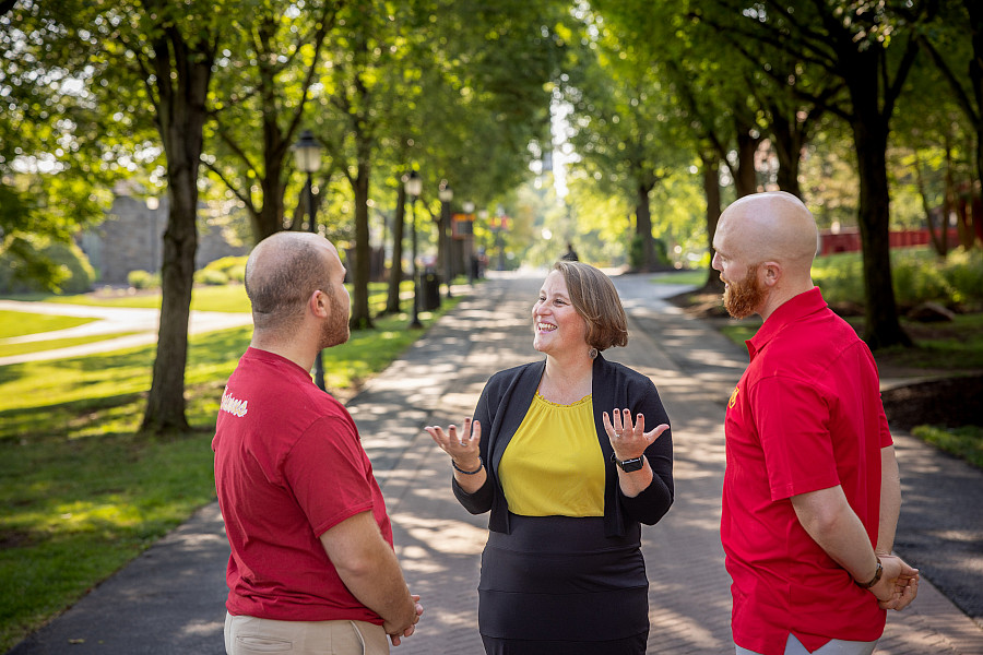 Katie Bean talking to colleagues Shawn and Justin