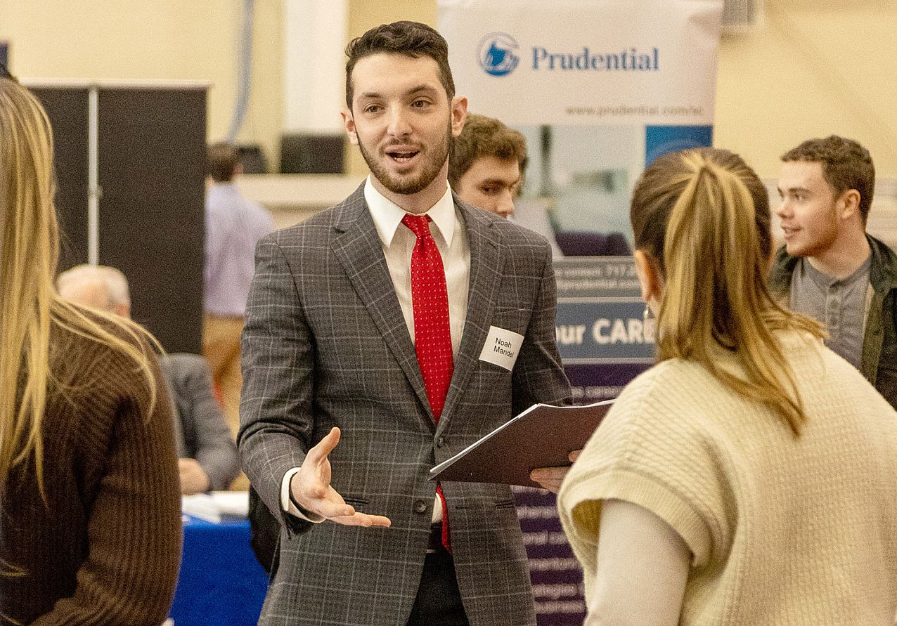 student at job fair talking