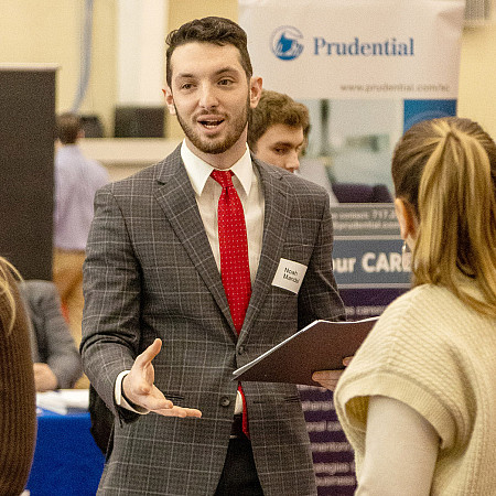student at job fair talking