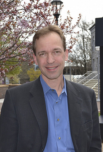 Headshot of John Spencer
